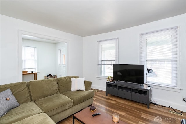 living area featuring baseboards and wood finished floors