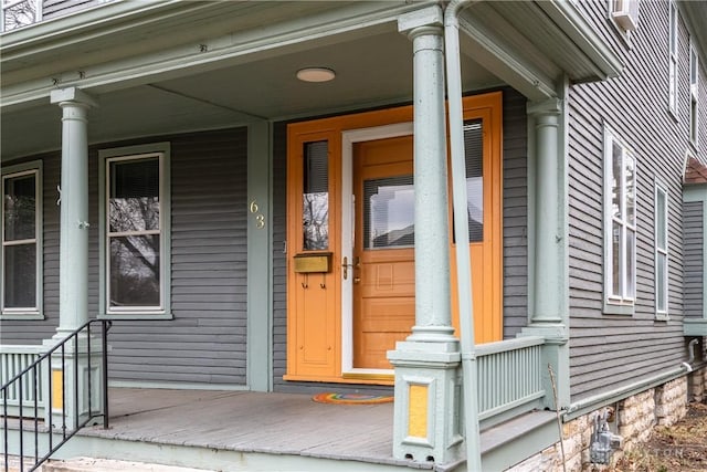 view of exterior entry with a porch