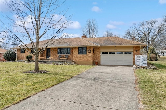 ranch-style house with brick siding, a front lawn, a chimney, driveway, and an attached garage