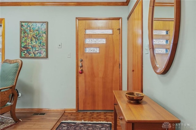 entrance foyer with crown molding and visible vents