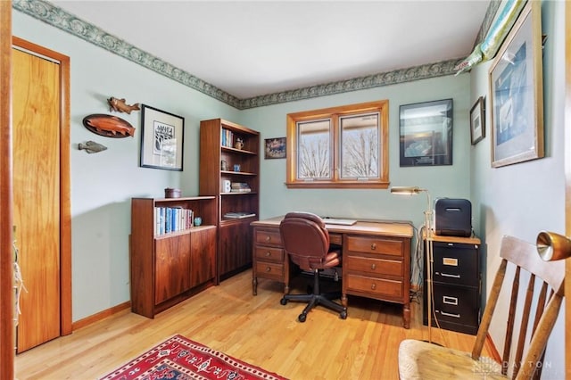 office featuring baseboards and light wood-style floors