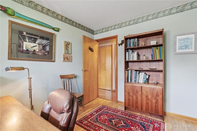 home office with baseboards and light wood finished floors