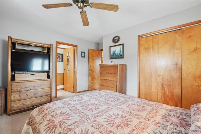 bedroom with a closet, baseboards, a ceiling fan, and carpet floors