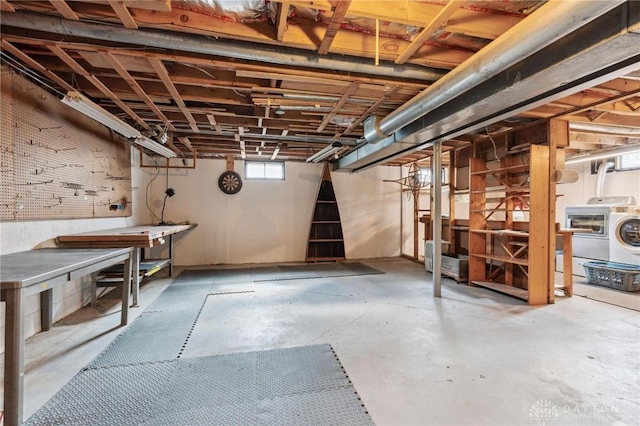 basement with a workshop area and washer / clothes dryer