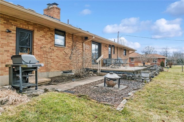 exterior space with a deck and a grill