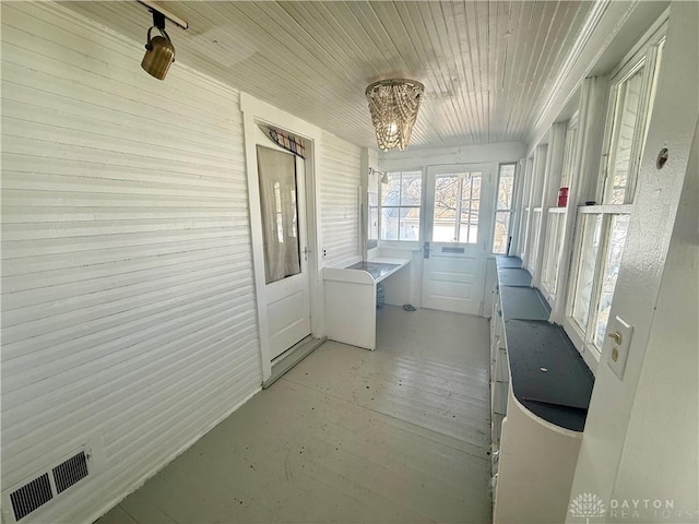 sunroom / solarium with visible vents and wood ceiling