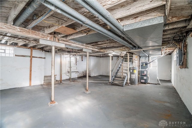 basement with stairway, heating unit, and electric water heater