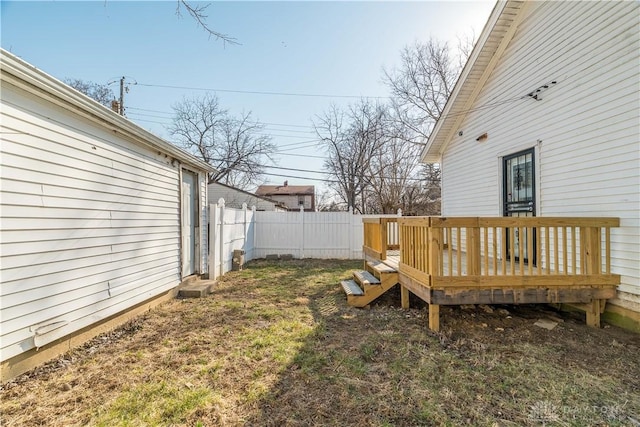 view of yard with a deck and fence