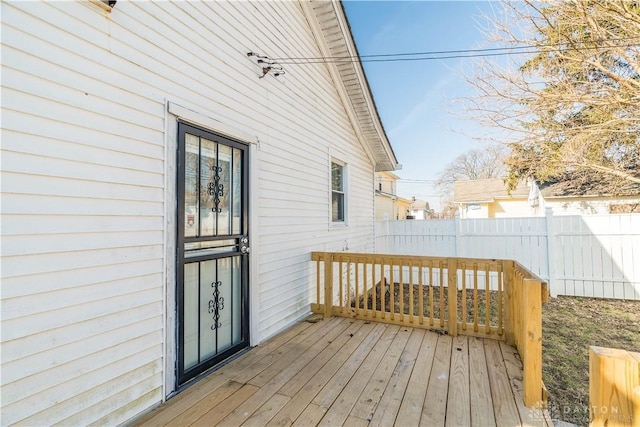 wooden terrace featuring fence