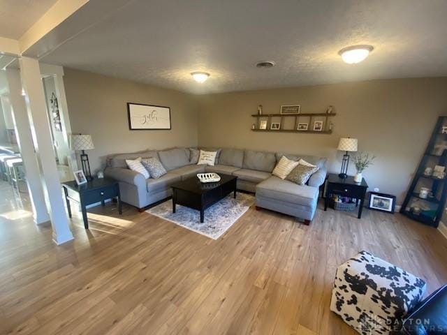 living area with visible vents and light wood-style flooring