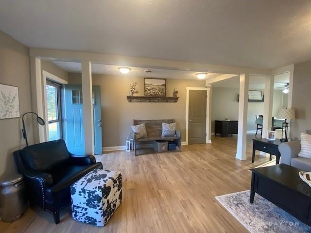 living room featuring light wood-type flooring and baseboards