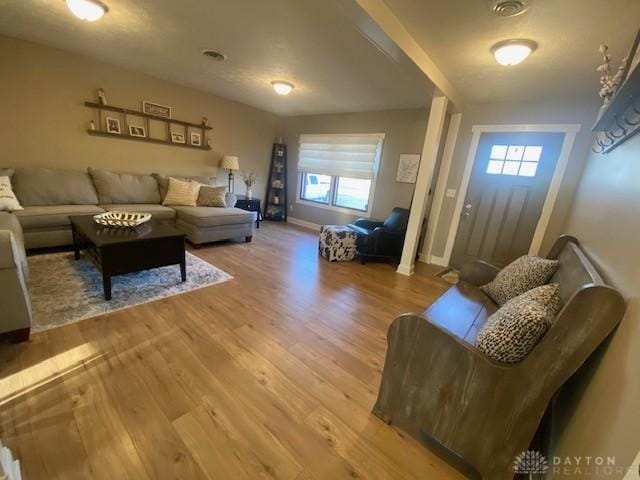 living room featuring wood finished floors and baseboards