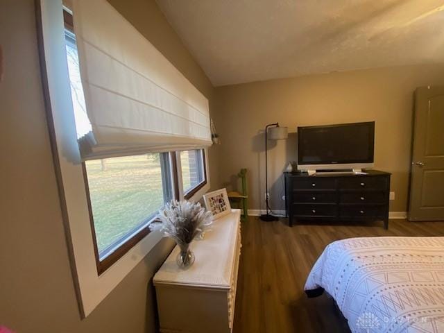 bedroom featuring dark wood-style floors and baseboards