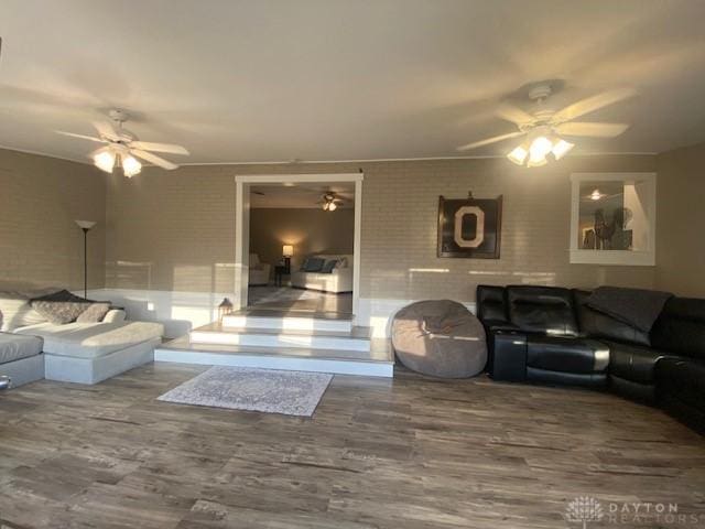 living room featuring a ceiling fan and wood finished floors