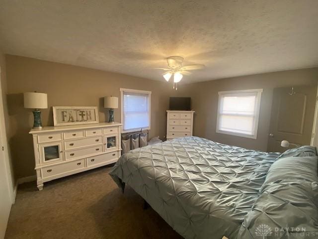 bedroom with dark colored carpet and ceiling fan