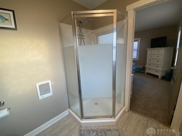 bathroom featuring visible vents, a stall shower, and wood finished floors