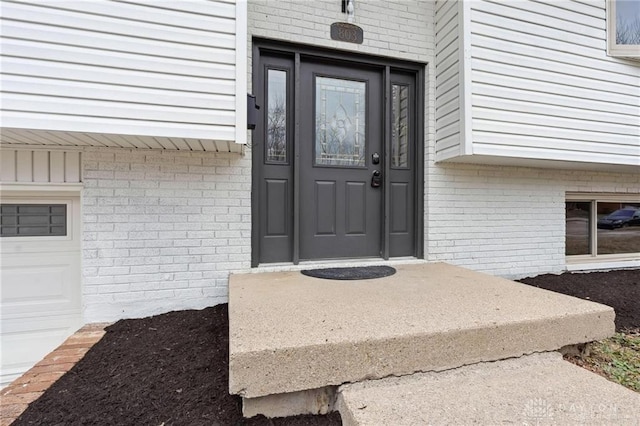 entrance to property featuring brick siding