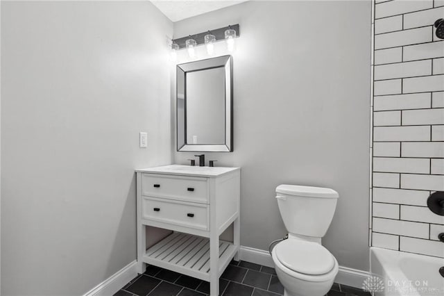 full bath featuring tile patterned floors, toilet,  shower combination, baseboards, and vanity