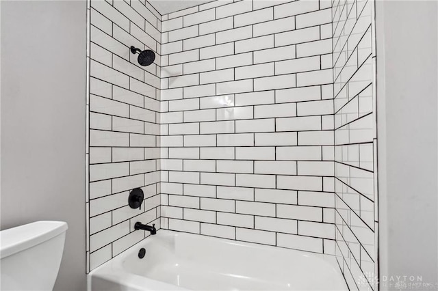 bathroom featuring toilet and bathing tub / shower combination