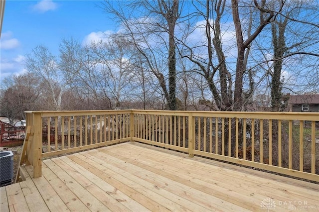 wooden deck featuring central AC unit