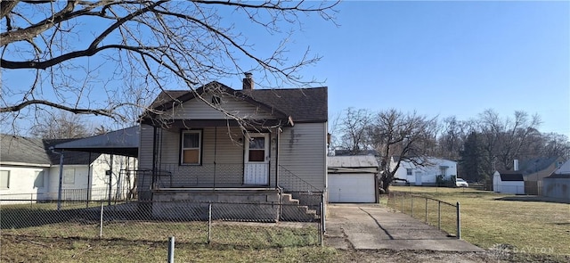 view of front of house featuring a fenced front yard, covered porch, an outdoor structure, a front yard, and a garage