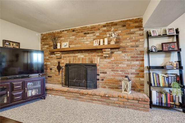 living area featuring a brick fireplace