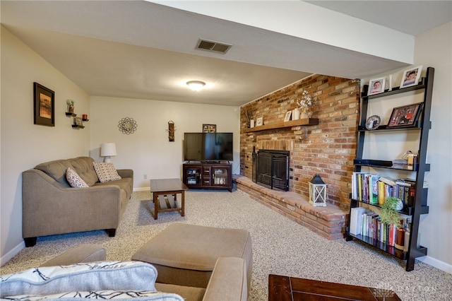 carpeted living room featuring visible vents, baseboards, and a brick fireplace