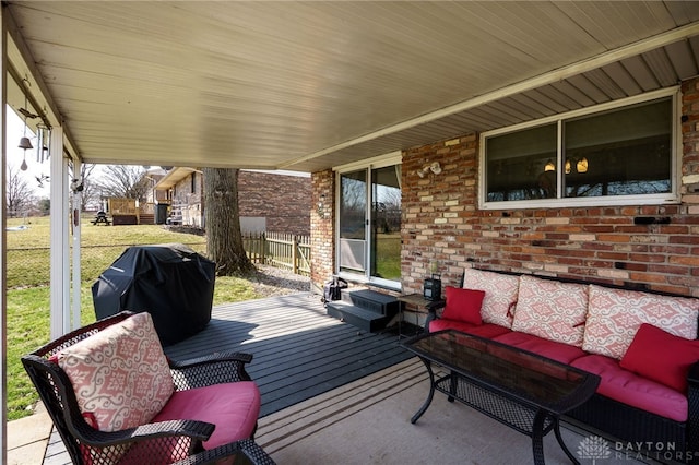 deck featuring area for grilling, an outdoor living space, and fence