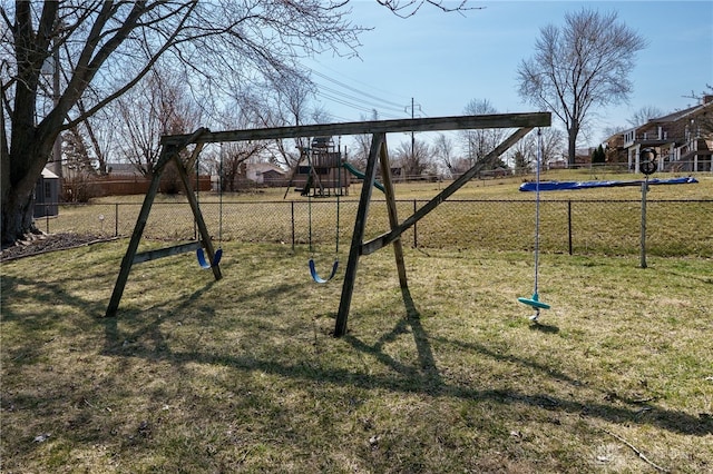 view of jungle gym with fence and a lawn