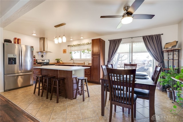 dining area with light tile patterned flooring and a ceiling fan