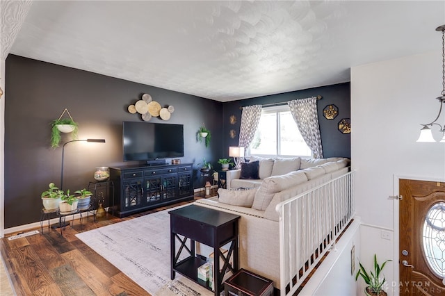 living room with wood finished floors and baseboards