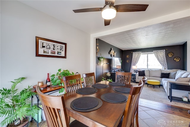 dining area featuring light tile patterned flooring and a ceiling fan