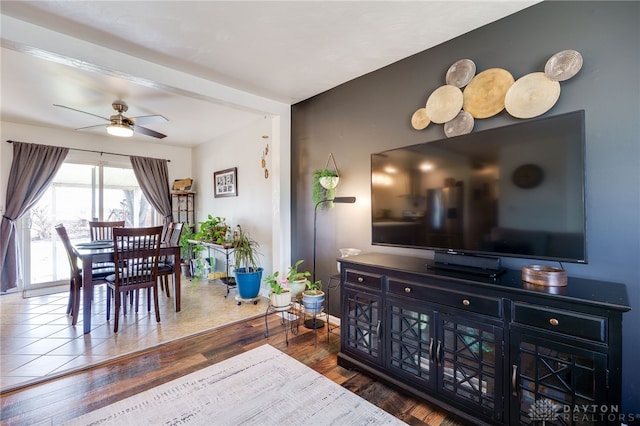 dining space featuring hardwood / wood-style flooring, a ceiling fan, and baseboards