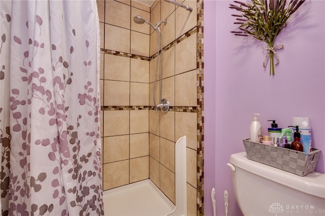 full bathroom featuring a shower stall and toilet