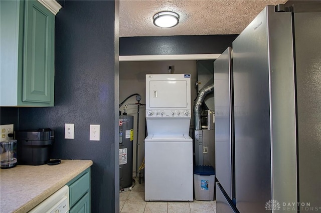 laundry area featuring laundry area, stacked washer and clothes dryer, a textured ceiling, a textured wall, and electric water heater