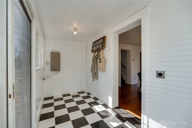 hall featuring tile patterned floors, stairway, and electric panel