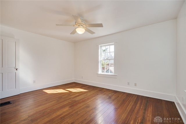 empty room featuring visible vents, baseboards, and wood-type flooring