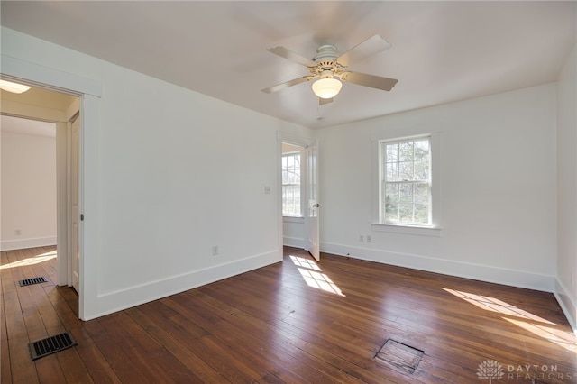 unfurnished room featuring visible vents, a ceiling fan, baseboards, and wood-type flooring