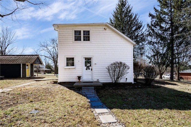 rear view of property with a yard