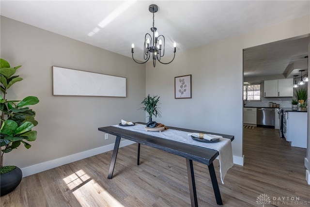 office space featuring a notable chandelier, dark wood-style floors, and baseboards