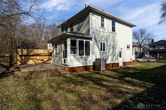 back of house featuring cooling unit, a yard, a wooden deck, and fence