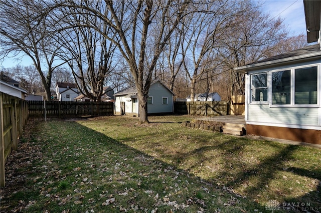 view of yard with an outdoor structure and a fenced backyard