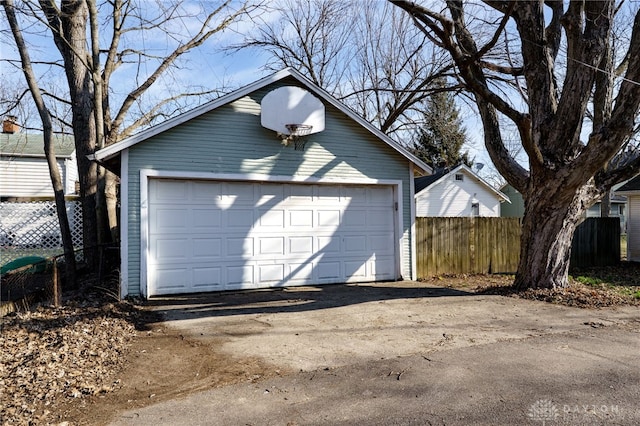 detached garage featuring fence