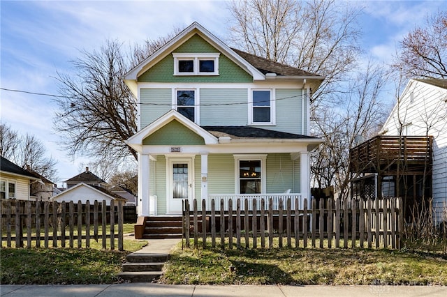 view of front of house with a fenced front yard and a porch