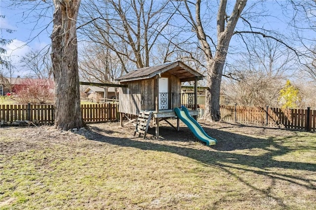 view of playground featuring a lawn and a fenced backyard