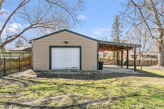 garage with fence and a garage