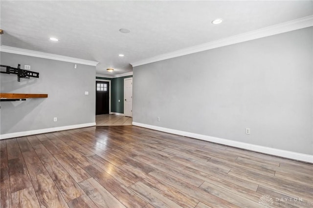 unfurnished living room with recessed lighting, crown molding, baseboards, and wood finished floors