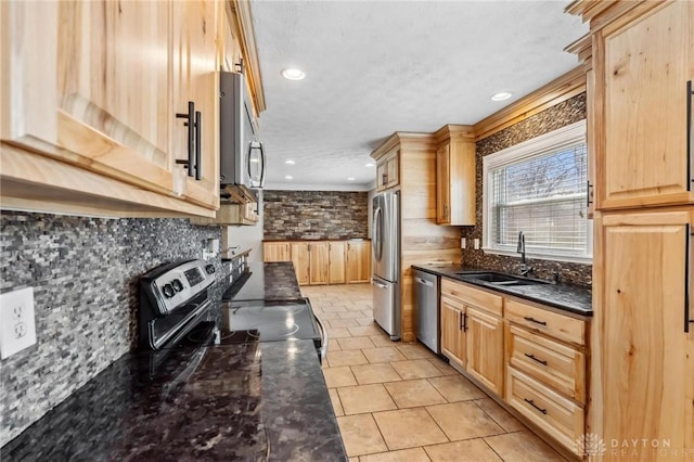 kitchen with light brown cabinets, light tile patterned floors, decorative backsplash, stainless steel appliances, and a sink