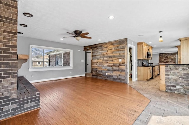 unfurnished living room featuring recessed lighting, baseboards, light wood-style flooring, and ceiling fan