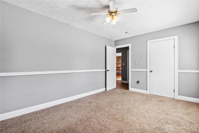 unfurnished bedroom with carpet flooring, a ceiling fan, and baseboards